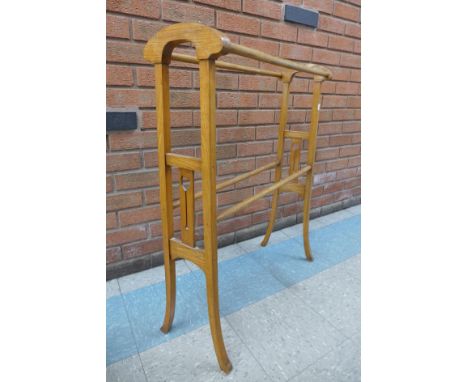 An Arts &amp; Crafts light oak towel rail 