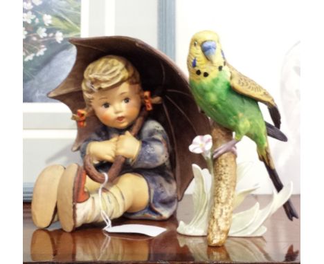 A LARGE GOEBEL FIGURE, YOUNG GIRL, UNDER AN UMBRELLA (A/F), TOGETHER WITH A GOEBEL FIGURE OF A BIRD ON A BRANCH (2).