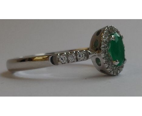 AN 18 CARAT DIAMOND & ENAMEL CLUSTER RING