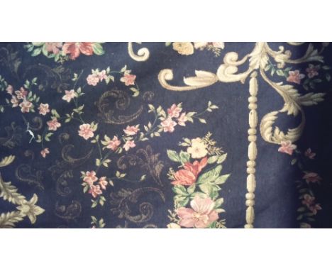 A BLACK GROUND FLORAL TAPESTRY, APPROX 8FT X 5FT.
