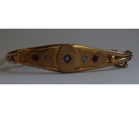 AN ANTIQUE STONE SET BANGLE