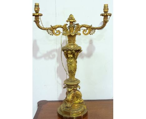 A BRASS TABLE LAMP, THE THREE GRACES WITH ROCOCO DOUBLE BRANCH LIGHTS. HEIGHT 36ins. 