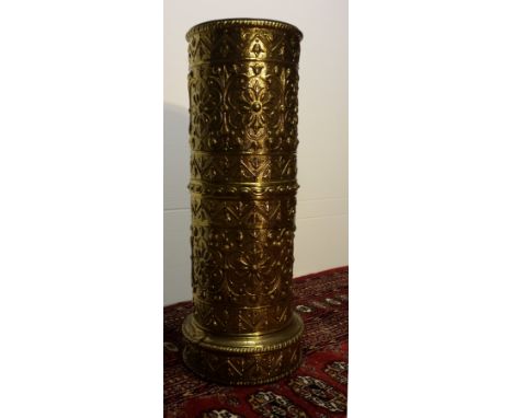 A HAMMERED CIRCULAR BRASS STICK AND UMBRELLA STAND. 