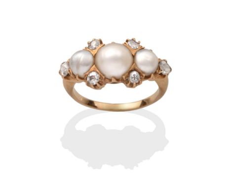 A Pearl and Diamond Ring, three graduated button pearls spaced by four old cut diamond accents and terminating at each end wi