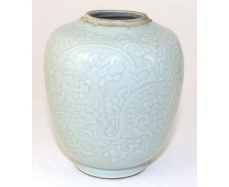 A Chinese Porcelain Jar, Jaijing reign mark, carved with dragons amongst lotus blossom, six character reign mark in underglaz