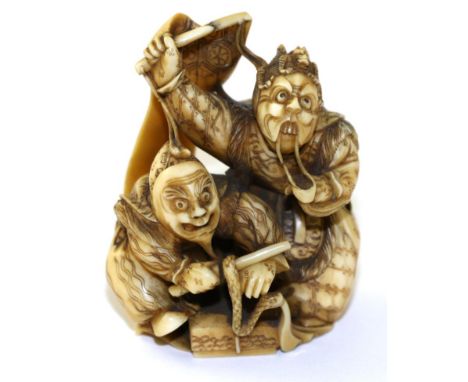 A Japanese Ivory Netsuke, Meiji period, as two actors wearing Noh masks and holding a banner, signed, 6cm high