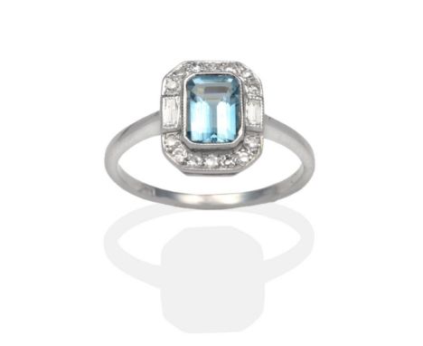 An Aquamarine and Diamond Ring, an octagonal cut aquamarine within a border of eight-cut and baguette cut diamonds in white m