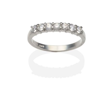 A Platinum Diamond Half Hoop Ring, seven round brilliant cut diamonds in claw settings, on a plain polished shank, total esti