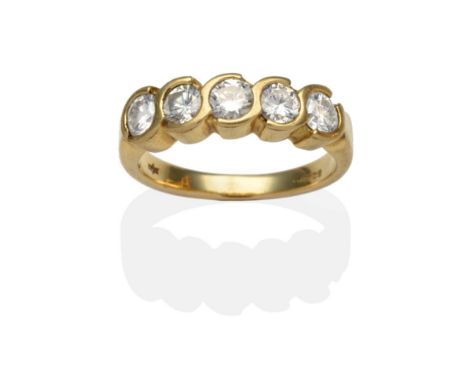 An 18 Carat Gold Diamond Five Stone Ring, round brilliant cut diamonds in half rubbed over scroll settings on a plain polishe