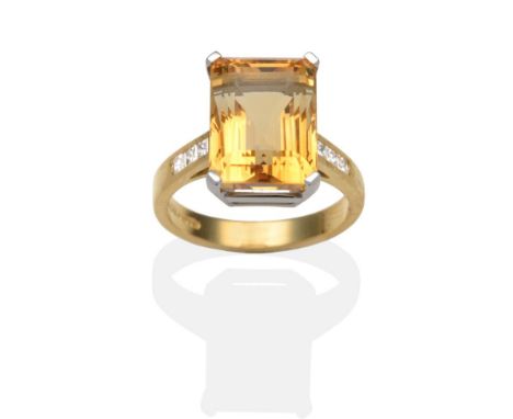 An 18 Carat Gold Citrine and Diamond Ring, an octagonal cut citrine in a white claw setting, to shoulders each inset with thr