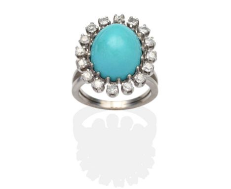 A Turquoise and Diamond Cluster Ring, an oval cabochon turquoise within a border of old cut diamonds in white claw settings, 