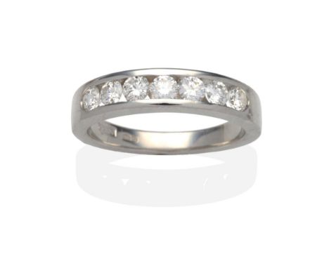 A Platinum Diamond Half Hoop Ring, seven channel set round brilliant cut diamonds on a plain polished flat sided shank, total