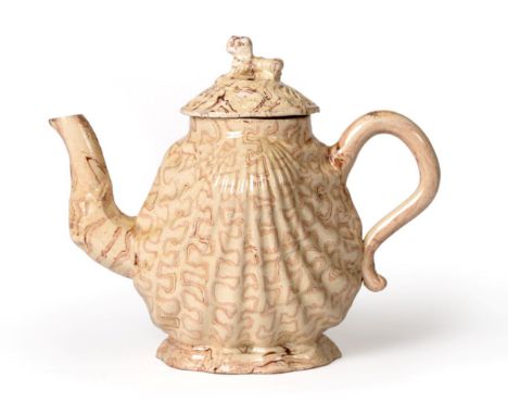 A Staffordshire Agateware Pecten Shell Teapot and Cover, circa 1750, with scroll handle and spout, marbled in brown and cream