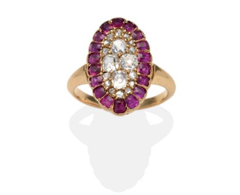 A Ruby and Diamond Navette Ring, an oval plaque set with old cut and rose cut diamonds within a border of off-round cut rubie