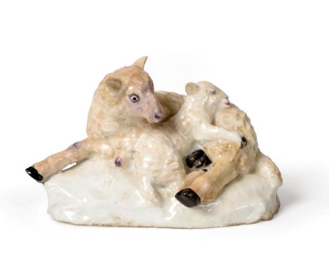 A Bow Porcelain Figure Group of Sheep, circa 1752, modelled as a recumbent sheep and lamb on a mound base, 13cm wide See illu