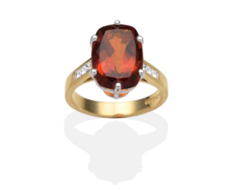 An 18 Carat Gold Citrine and Diamond Ring, a cushion cut citrine in a white claw setting to shoulders each inset with three p