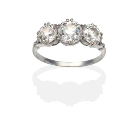 A Diamond Three Stone Ring, graduated old cut diamonds in white claw settings, to forked shoulders on a plain polished shank,