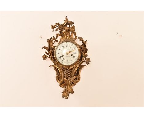 An 18th Century gilt brass cartel or rococo style clock by Denis Gault of Paris, with gilt brass casement and decorated in th
