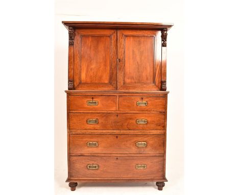 A Very Good 19th century mahogany Campaign Chest/ Cabinet standing on four turned feet, the chest of typical campaign form, i