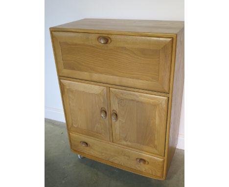 An Ercol blonde elm bureau cabinet with 2 doors and a drawer in good condition, minor scratches to top, 110 cm tall x 82cm x 