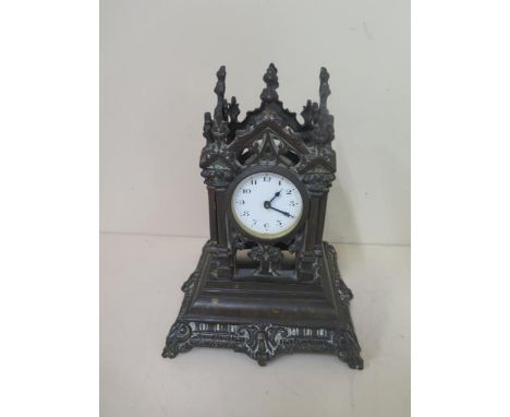 A bronze monument mantle clock, 21cm tall, movement appears overwound otherwise good condition 