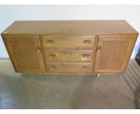 An Ercol blond elm sideboard with 3 drawers and 2 cupboard doors, 67cm tall, 156cm x 43cm, in good condition with some small 