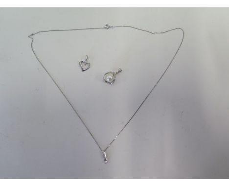 A 9ct white gold pendant on chain, a white gold pendant, approx 1.3grams and a 14ct pearl pendant, approx 1.5grams 