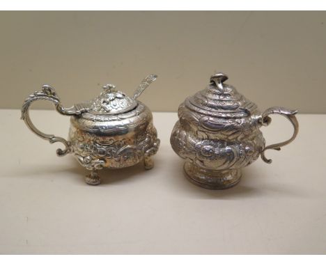 2 x Georgian silver embossed mustards both London 1818, one with a gilt interior the other with a later blue glass liner with