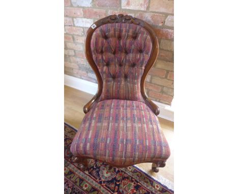 A reupholstered button back Victorian fireside chair 