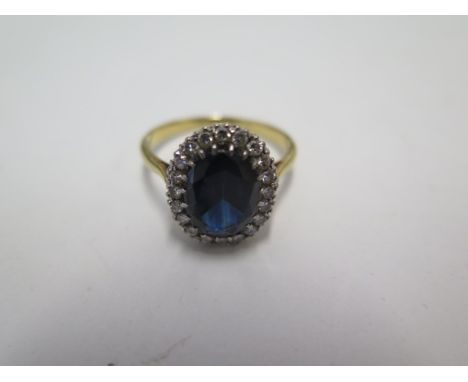 An 18ct yellow gold diamond and dark blue sapphire ring, size R, approx 4.6grams, marked 18ct. Head size 15 x 12mm with some 