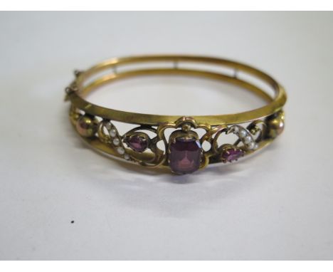 A hallmarked 9ct gold amethyst and pearl bangle, 7cm x 6cm, approx 10.8 grams, generally good condition, missing safety chain
