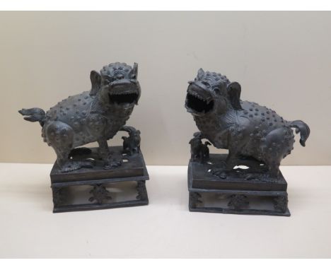 A pair of bronze dogs of Fo, 22cm tall x 20cm long, generally good with good patina, firing crack to one base and other firin