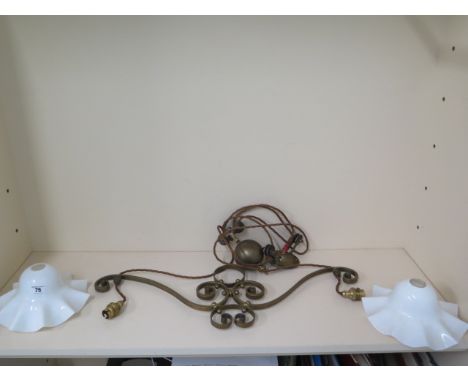 A brass rise and fall twin branch hanging lamp with white glass shades 