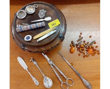 A mixed lot comprising small silver and white metal items, an early 20th century compass, a beaded needle case, loose amber b