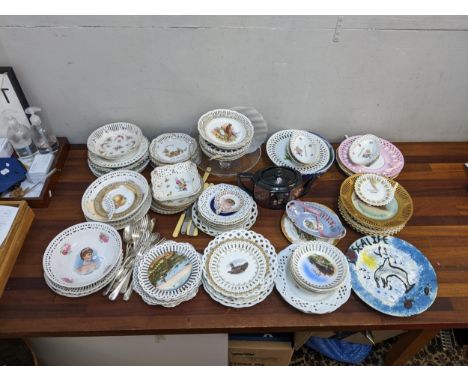 A collection of ribbon and other decorative plates and bowls to include examples, inscribed 'A Present from....' and items 