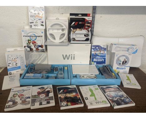 A Nintendo Wii console and accessories to include 2 hand controllers with motion plus Nunchuk and manuals, balance board, F1 