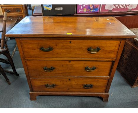 An early 20th century walnut chest of three long drawers and on bracket shaped feet 83cm h x 98.5cm w Location: 