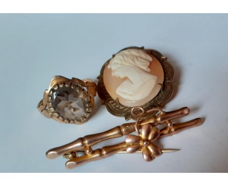 A 9ct gold dress ring with smoky brown cabochon on a raised mount, total weight 3.2g together with a 9ct gold bar brooch stam