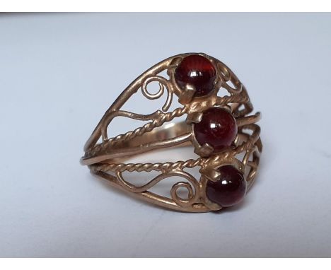 A 9ct gold and 3 red stone cabochon ring in the Eastern style with filigree design, total weight 2.97gLocation: CAB5 