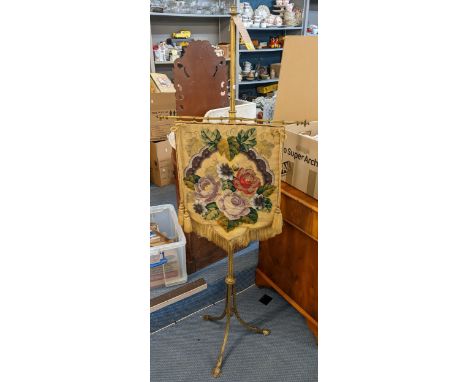 A Victorian brass pole screen having tapestry banner and on a tripod base 154cm h x 57cm w Location: 
