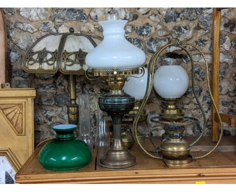 A selection of oil lamps, together with a French style table lamp 
