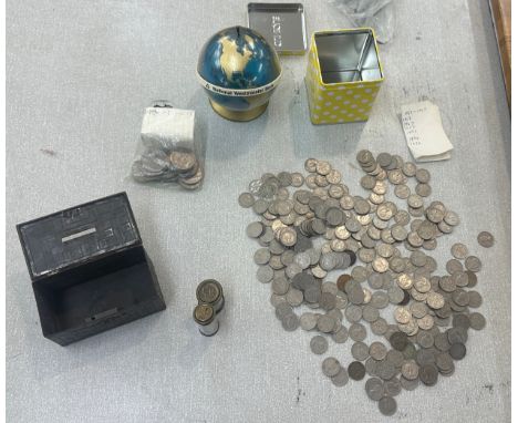 Four vintage money boxes and a selection of six penny pieces
