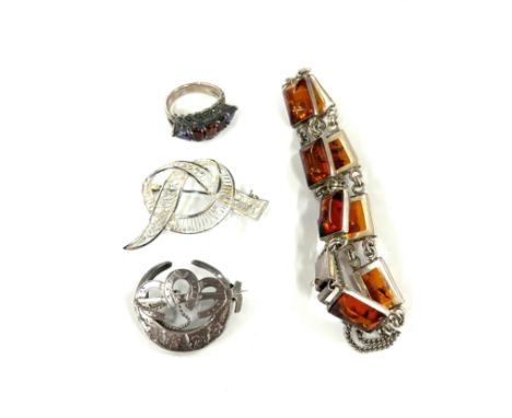 Selection of silver jewellery includes amber bracelet, brooches, ring etc