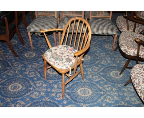 An Ercol blond elm armchair with arched back 