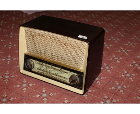 A vintage Ekco WHF/AM radio with brown barcolite case