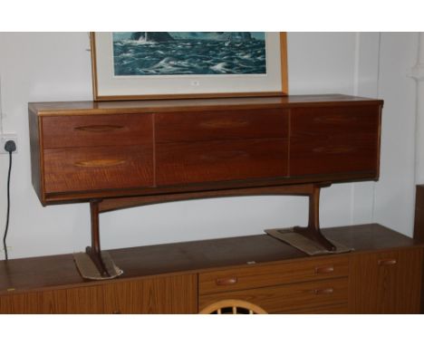 A 1970's teak dressing table of G Plan design fitted 6 drawers on shaped tresle legs 92 cm x 154 cm x 43 cm (lacking mirror)