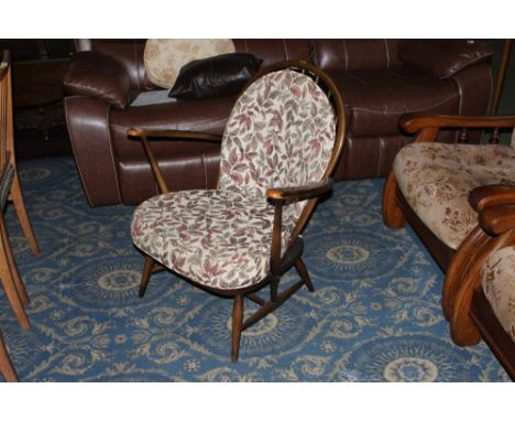 An Ercol dark elm armchair with arched back 