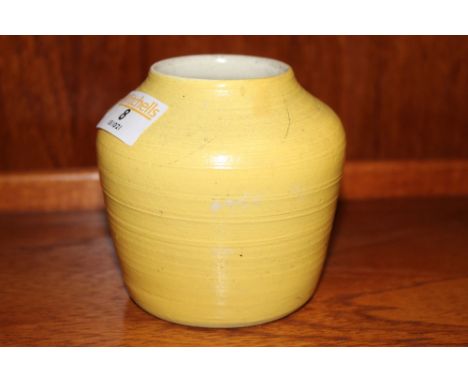 An E. Taylor for Poole yellow glazed pottery vase 9.5 cm high inset to base and dated 1955.