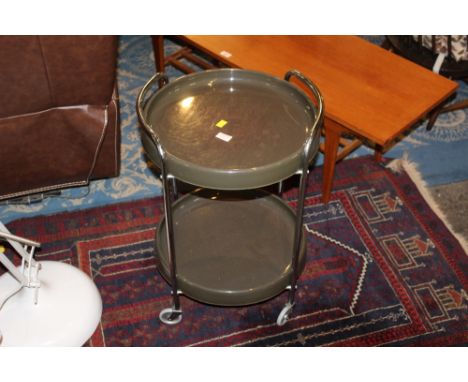 A vintage chrome and grey plastic 2 tier plastic trolley table, of circular form 62 cm x 43 cm