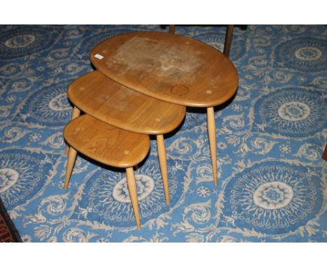 A nest of 3 ercol blond elm "Pebble" occasional tables the largest 40 cm x 65 cm x 45 cm (largest taable with water marks 